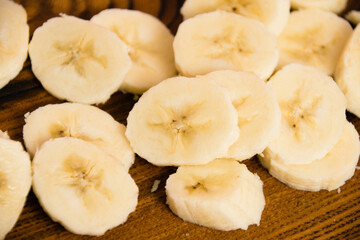 Banana slices on a dark wooden background