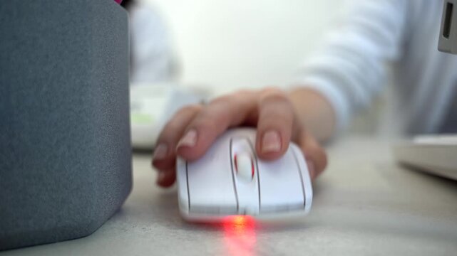 Close up of female administrator hand using mouse working on computer Technology and business concept.
