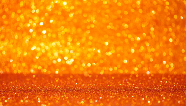 Glittery vibrant orange background with dreamy bokeh effect. Abstract backdrop.