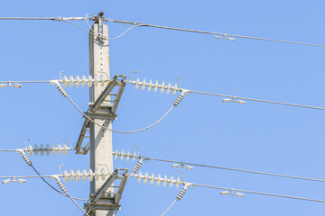 Power lines and insulators delivering electricity on a clear day