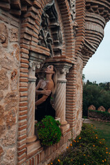A beautiful lady walking through the grand halls of an ancient castle