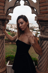 A beautiful lady walking through the grand halls of an ancient castle