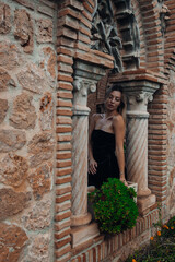 A beautiful lady walking through the grand halls of an ancient castle