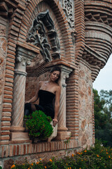 A beautiful lady walking through the grand halls of an ancient castle