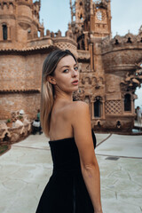 A beautiful lady walking through the grand halls of an ancient castle