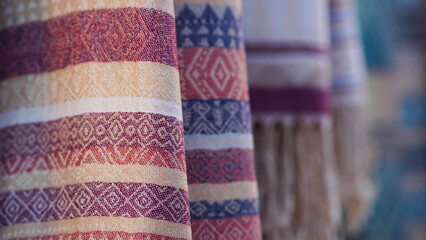 Close-up images of local fabric patterns displayed at tourist attractions in Thailand.