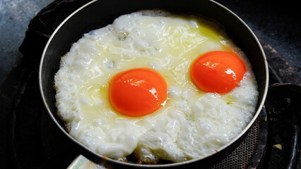 Two fried eggs in a pan