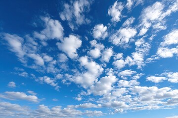 Vibrant blue sky with fluffy white clouds on a clear day.