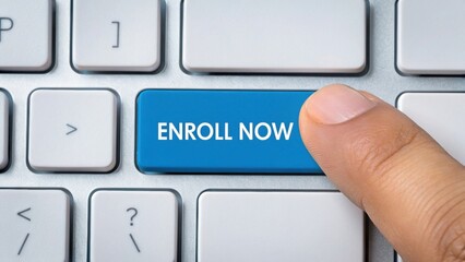A finger presses a blue "ENROLL NOW" key on a white computer keyboard, symbolizing online enrollment or registration.