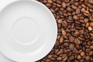 Coffee beans and a plate in close-up.