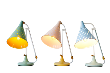 Three pastel colored desk lamps with polka dots illuminate a dark background