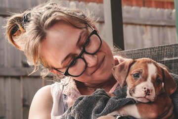 A woman and her new puppy bond