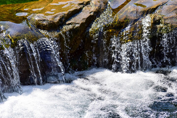 The view of the waterfall in a public park. Splashing Water, water flowing. Nature concept.