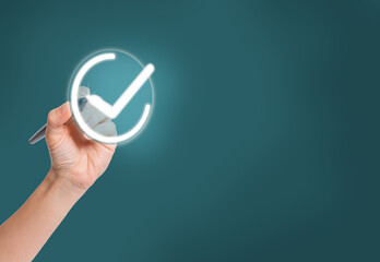Female hand with pen marking correct option with check mark or agree. Checklist concept, check...