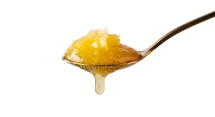 A Spoonful of Golden Ghee Dripping, a Pure Clarified Butter for a Ketogenic Diet, Isolated on White Background.