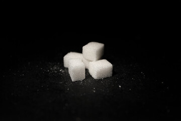 Geometric Pile of Sugar Cubes on Black Table – High Contrast Close-Up for Minimal Food Concept