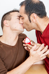 Gay Lifestyle: Marriage Proposal. A spontanous kiss  between a same sex couple celebrating their engagement. From a series of related images.