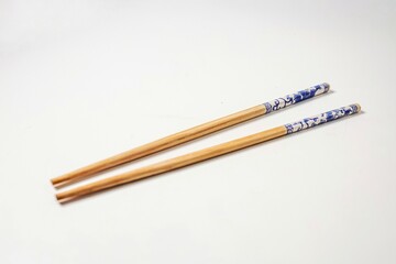 Wooden chopsticks on white background	