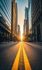 Obraz premium Golden hour sunlight illuminates city street leading to tall buildings