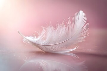 Obraz premium A single delicate white feather rests on a soft pink surface with its reflection visible below creating a serene and ethereal