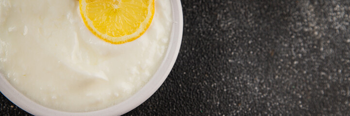 Lemon yogurt natural product skyr sour milk skir fresh delicious gourmet food background on the...