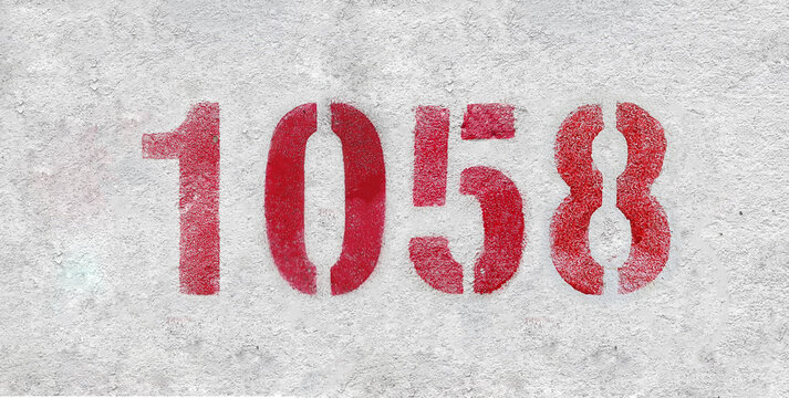 red spray-painted number 1058 sprayed onto a white wall.