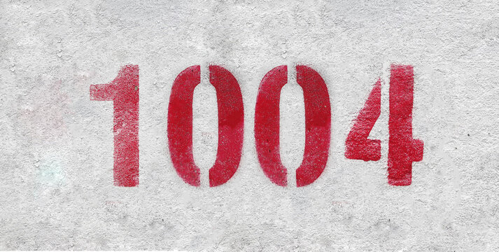 red spray-painted number 1004 sprayed onto a white wall.