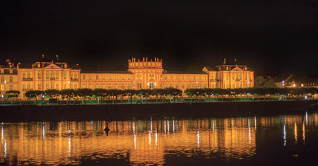 Night time view of  a Palace located on the River Rhine in Germany.  Beautifully illuminated at night with light reflection in the river. 