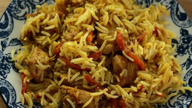 A dish with rice and meat.
Uzbek dish in a cauldron with rice and lamb.
Cooked pilaf on a plate close-up.
Traditional Uzbek dish on the table