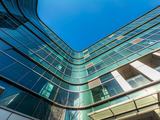 Modern Architectural Marvel Against a Bright Blue Sky: A Dynamic Perspective