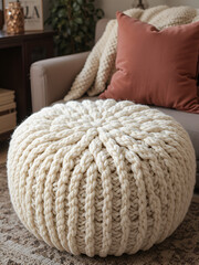 Soft chunky knit blanket and pouf in stylish room interior
