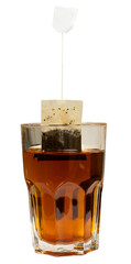 closeup tea bag in a transparent tea cup, black tea in tall glass isolated on white background. 
