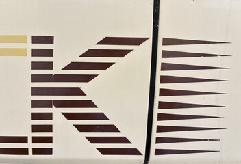 Old van bodywork with geometric letter ornament.