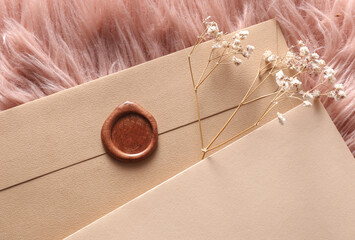 Vintage envelope with wax seal and stamp, dry grass on pink fluffy background, Wedding invitation