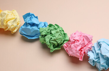 Colored balls of crumpled paper on a beige background. Lack of ideas, stress, depression, business...