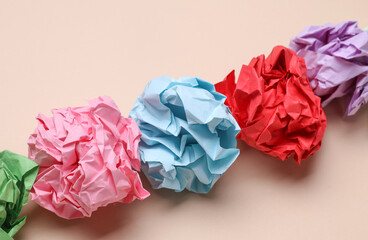 Colored balls of crumpled paper on a beige background. Lack of ideas, stress, depression, business...