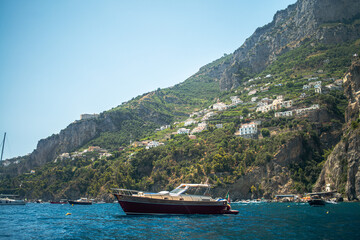 A breathtaking view of the Amalfi Coast showcasing dramatic cliffs, crystal-clear blue waters, and...