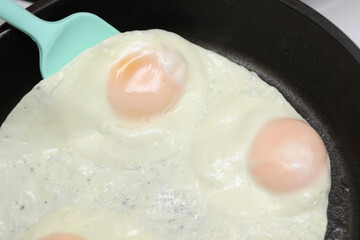 Eggs are fried in a frying pan. Cooking breakfast