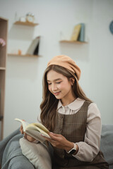 Young woman reading a book in cozy living room, wearing stylish outfit and fashionable beret, enjoying leisure time in modern interior space