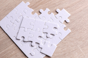 White unassembled jigsaw puzzle on the table