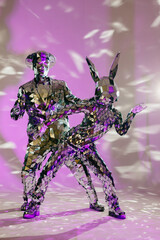 Mirror dancers performing on purple stage with special effects