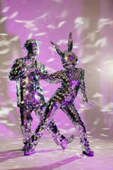 Mirror dancers performing on purple stage