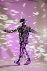 Mirror man dancing with purple stage lights reflecting on suit