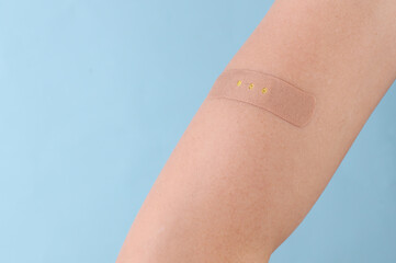 Medical plaster applied to arm after vaccination