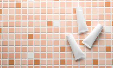 White Cream tubes on tiles. Beauty concept. Mockup for design. Top view