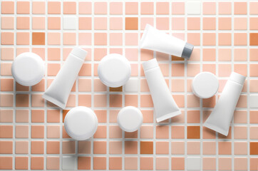 White Cream tubes and jars on tiles. Beauty concept. Mockup for design. Top view
