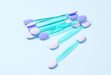 Set of applicators for makeup on a blue background