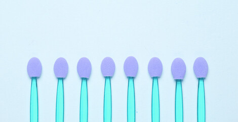 Set of applicators for makeup on a blue background