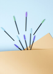 Set of brushes for combing eyelashes on pastel background. Beauty concept