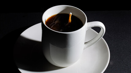 coffee with a drop of creamer in motion